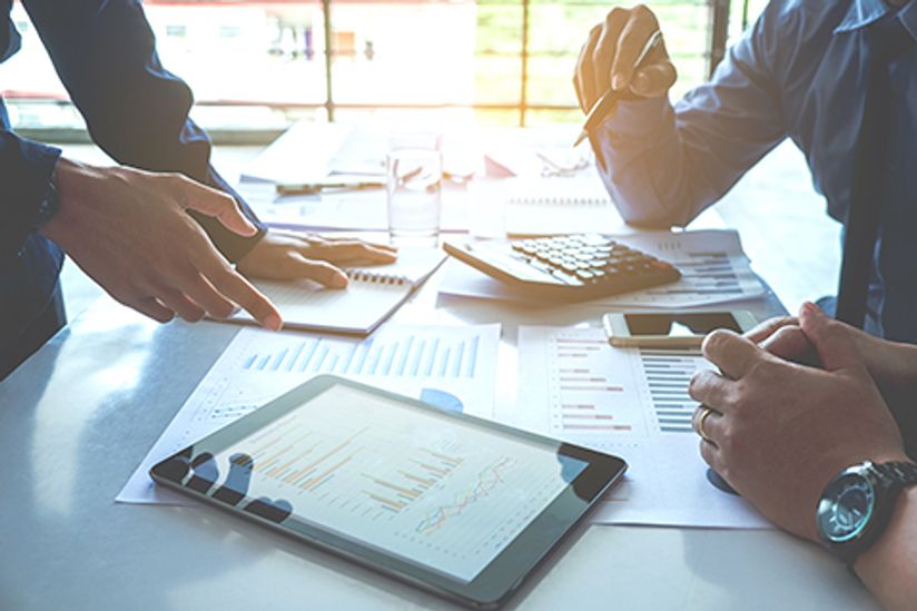 close up of desk with analytics and technology
