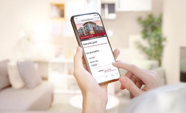 person holding phone with customized branding that available for communities using SmartRent's self-guided tours product