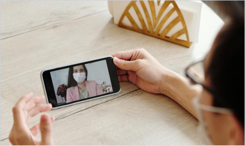 person on video call with face masks on