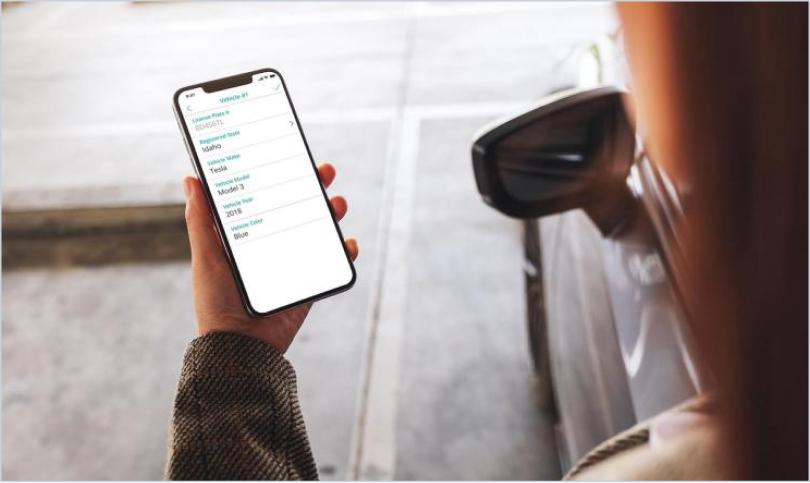 person holding phone with the SmartRent parking app on screen
