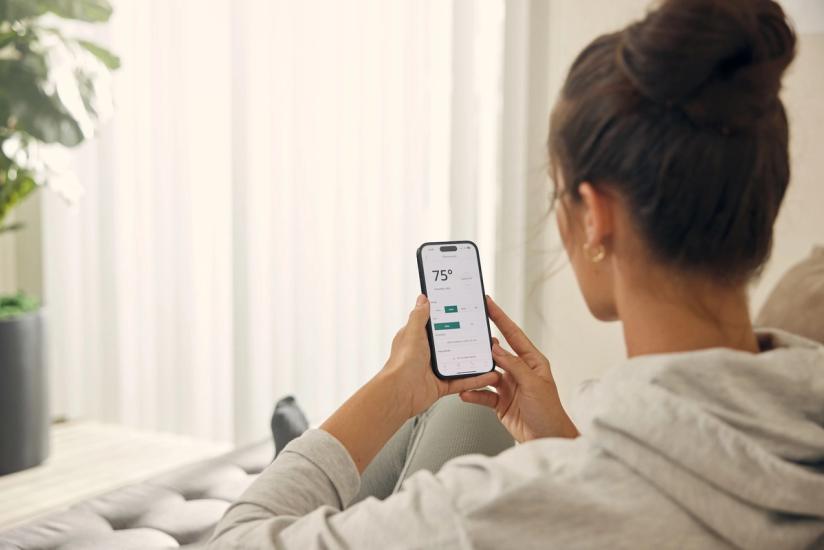 Multifamily resident uses SmartRent app to control her smart thermostat