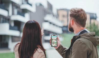 Two prospective residents use a self-guided touring app while touring an apartment community.