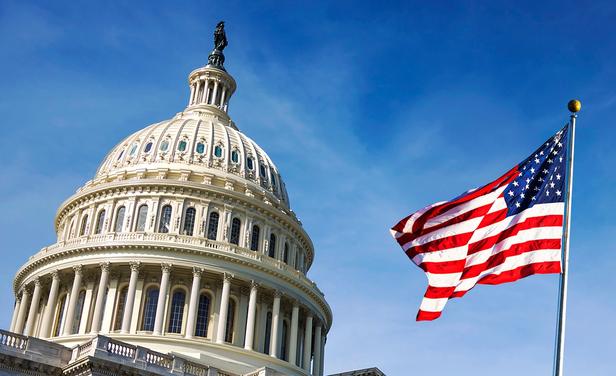 American flag waving on Capitol Hill. 