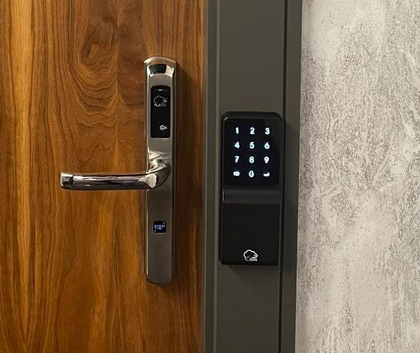 A TLJ Zpad and Rezlok smart lock installed on a unit door.