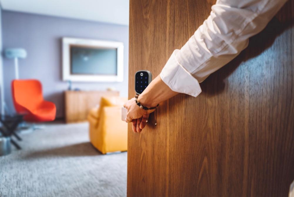 person entering a home with smart lock on the door