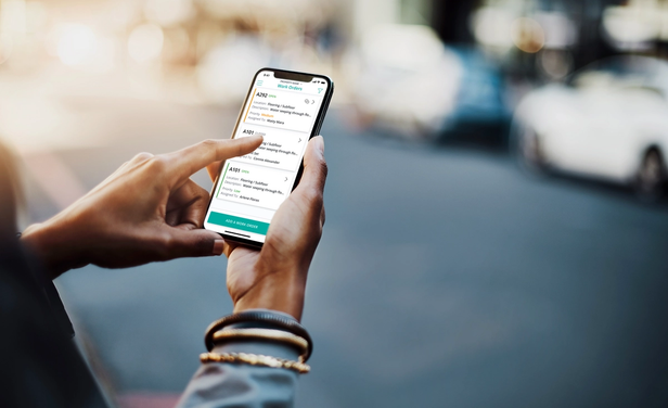 person holding phone using SmartRent Community Manager app
