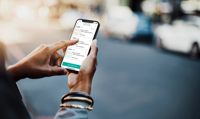 person holding phone using SmartRent Community Manager app