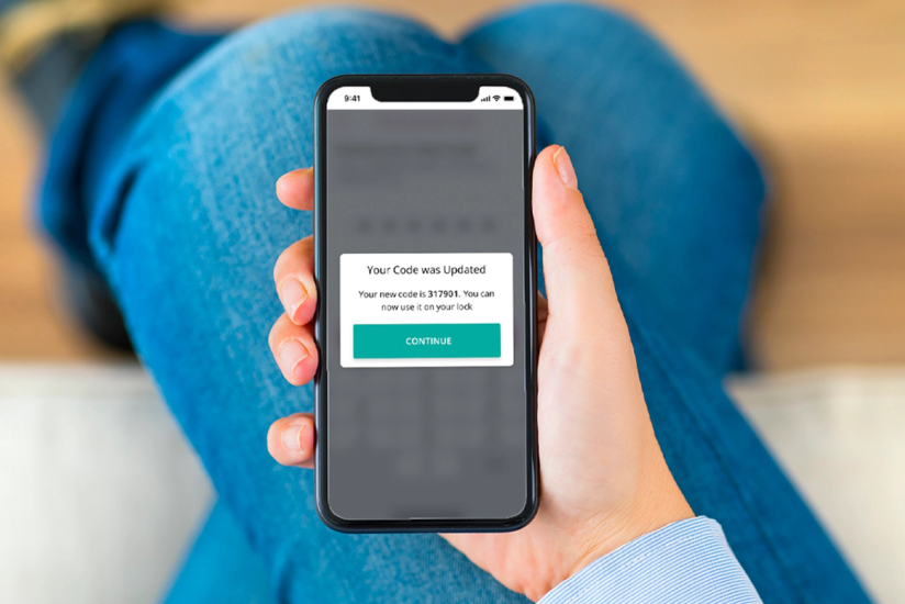 person holding phone showing success code update message from SmartRent app