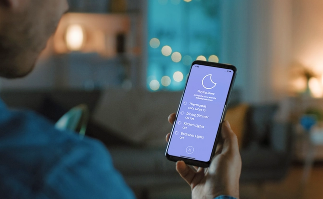 Image of person controlling smart lights on phone