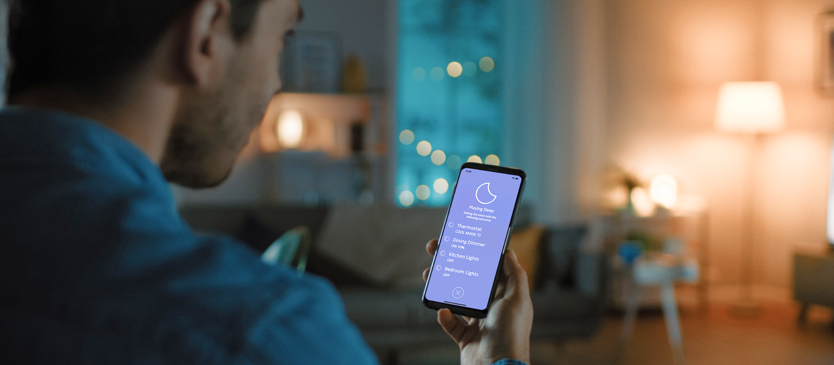 Image of person controlling smart lights on phone