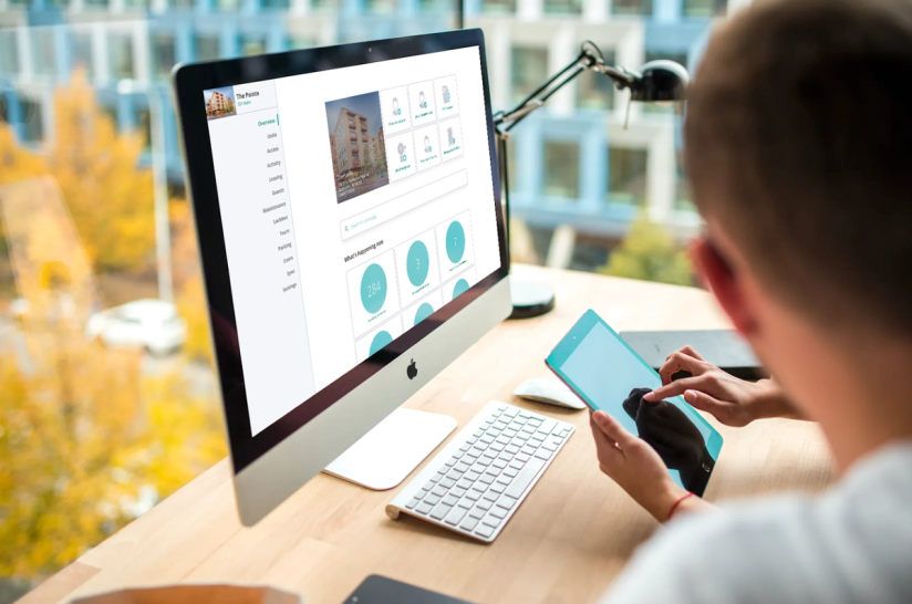 SmartRent users view their management dashboard on a desktop computer.