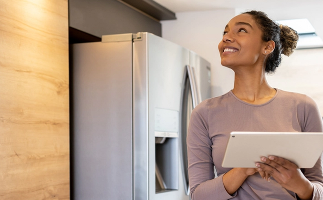Young adult operates a smart home using a tablet. 